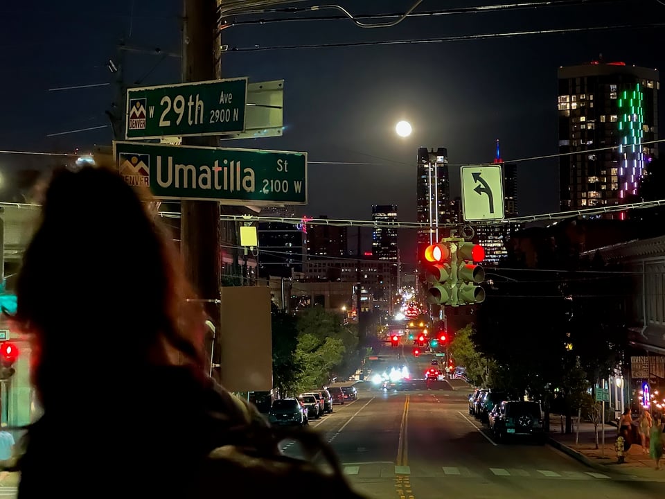 the moon hangs above 15th street