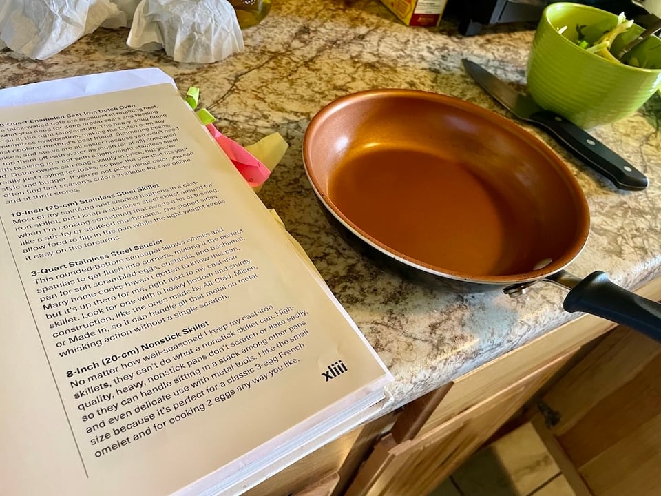 A small pan by an open book