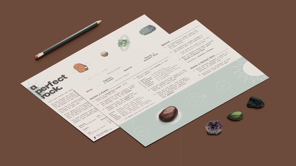 A perfect rock game, laid out on a table with rocks and a pencil.