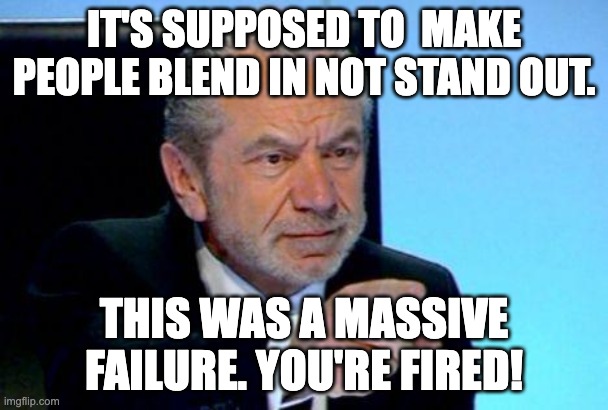 A screenshot of Alan Sugar in the Apprentice boardroom. Top text reads: It's supposed to make people blend in not stand out. Bottom text reads: This was a massive failure. You're fired!