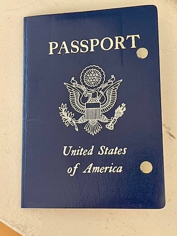 a photo of a U.S. passport cover with two holes punched into it