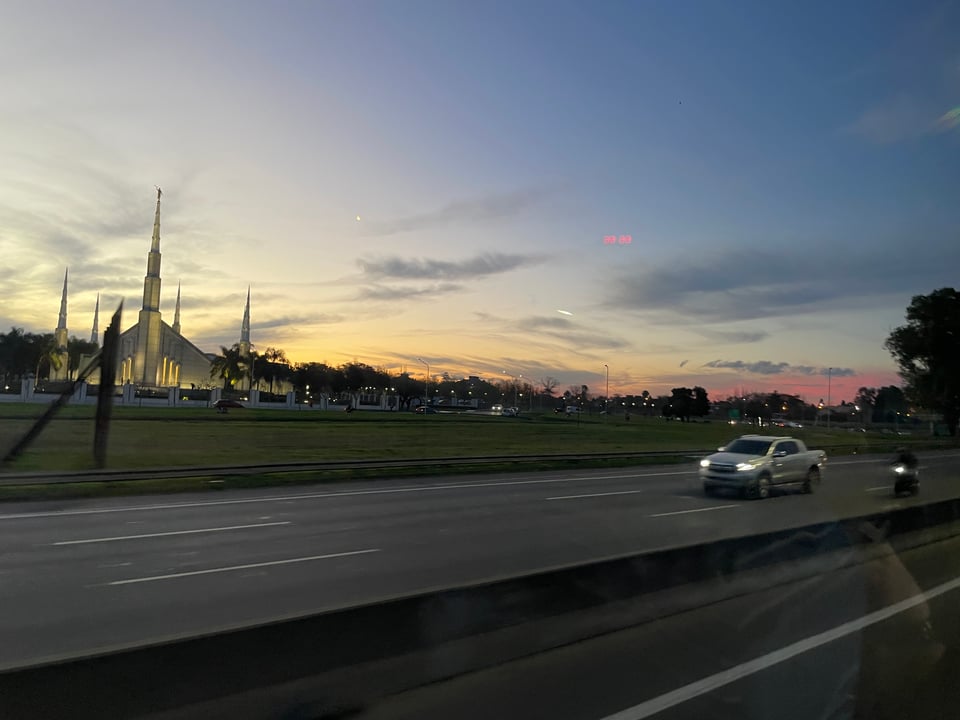 Sunset along the highway with the Mormon church behind the highway in Buenos Aires.