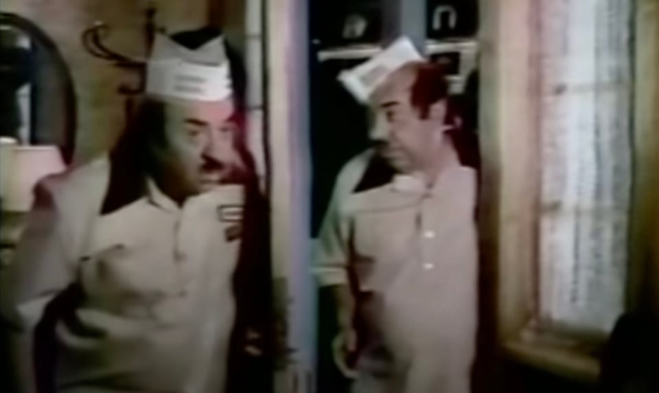 A shot from a famous old Dunkin Donuts commercial showing a DD worker constantly going out to “make the donuts” then coming back home saying “made the donuts.” At the end, he starts to go out but is stopped by his future(?) self, having already made the donuts.