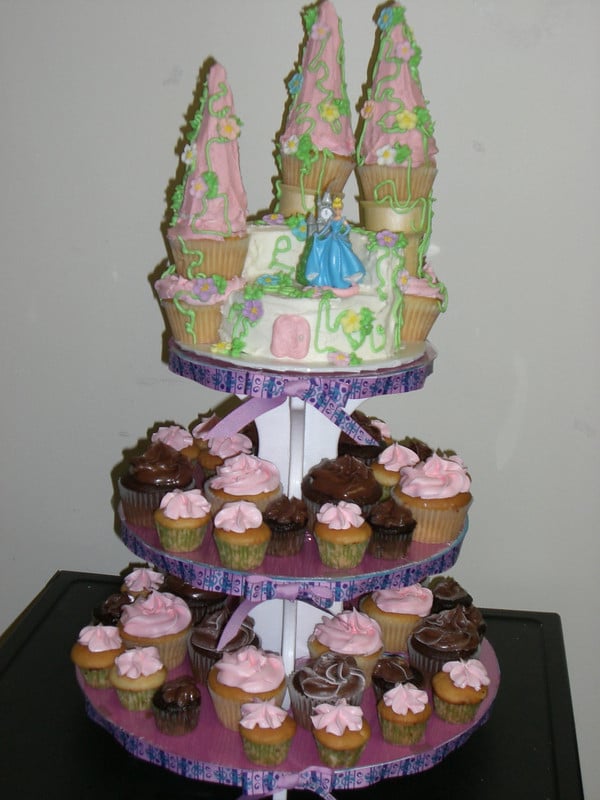 a three tiered cake stand with cupcakes on it