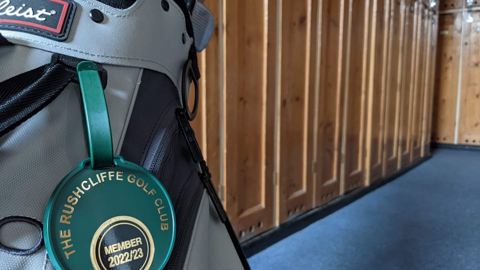 Clubhouse locker room at Rushcliffe Golf Club, tall wooden lockers in background, golf bag and membership bag tag in foreground.