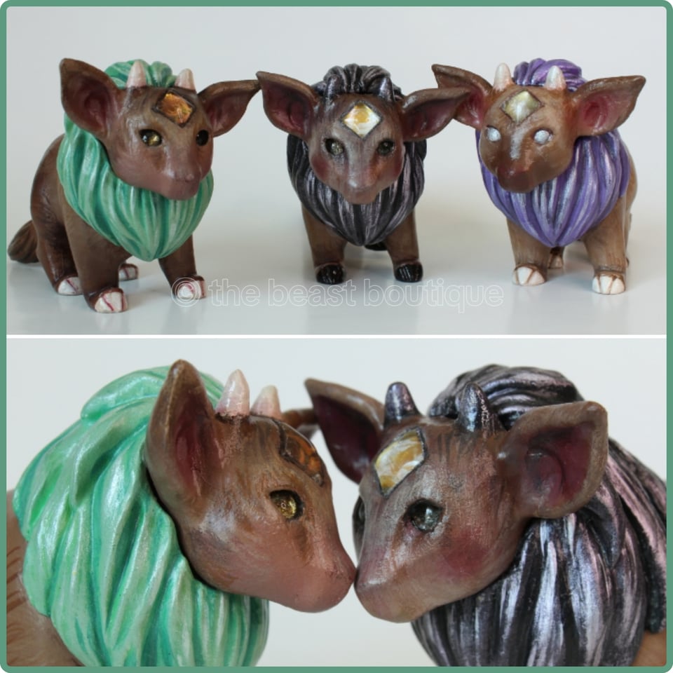 A collage showing the three fantasy bull calf figurines with lion manes. All of them are brown with golden gems in their foreheads, and left to right, their manes are light green, black, and light purple. the lower half of the collage shows the two with green and black manes touching noses.