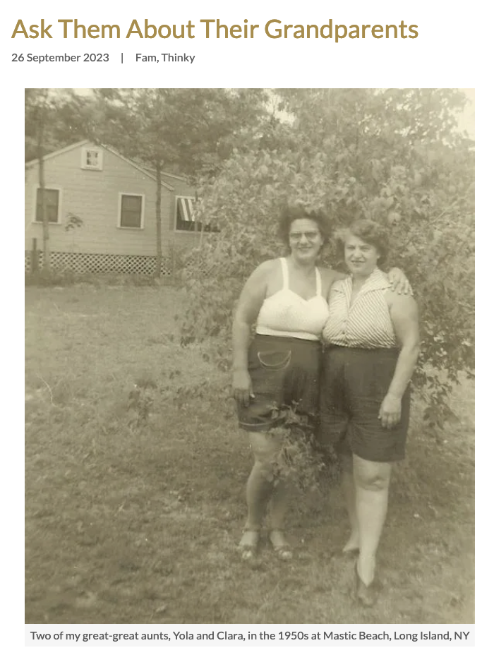 Image alt text: Two Abruzzese femmes in shorts and tank tops stand in fromt of a small tree, smiling at the camera