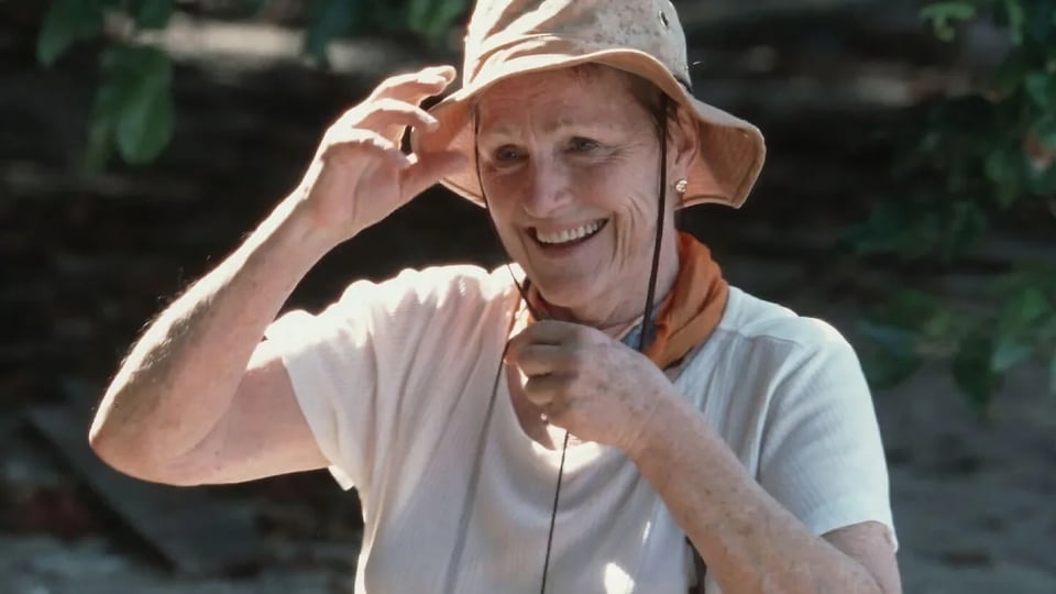 an older woman wearing a hat