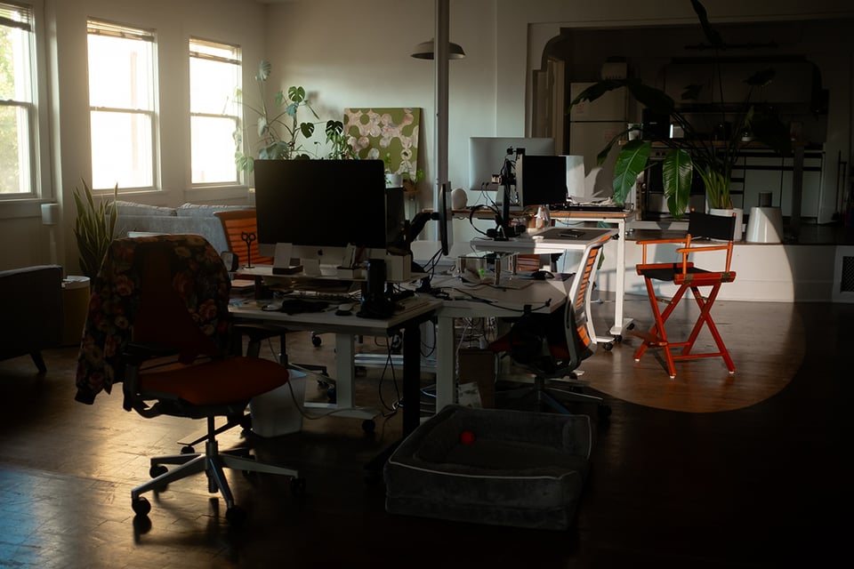 A director’s chair spotlit in the space.