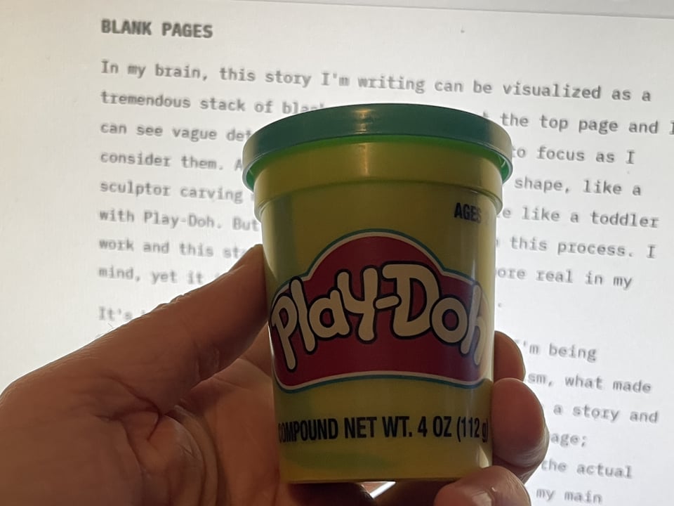 An image of R.A. Young holding up a small tub of Play-Doh in front of their pre-published newsletter.