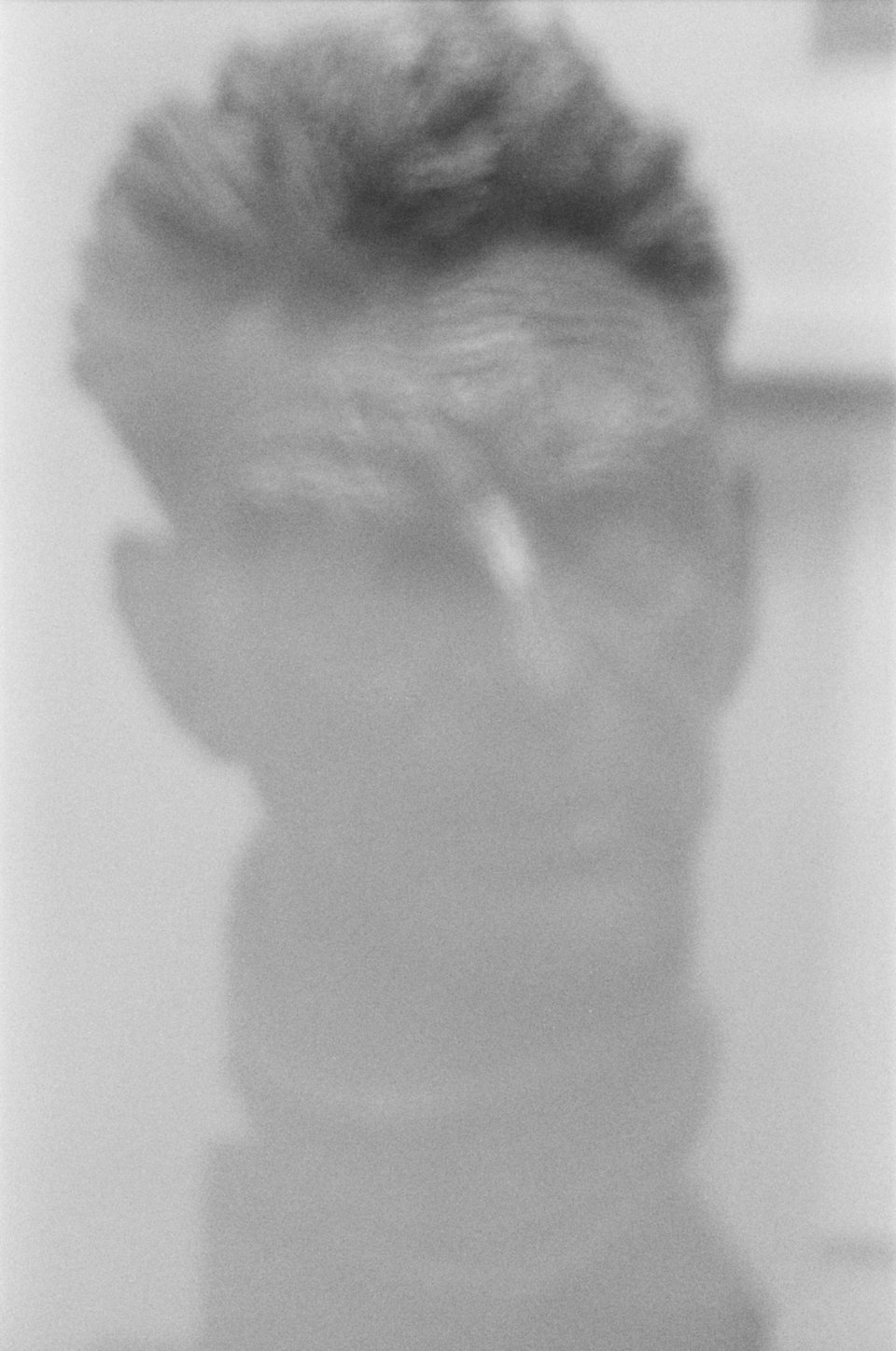 A blurry picture of a bust of Samuel Beckett