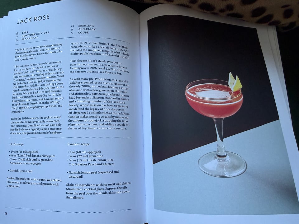 Signature Cocktails book open to spread featuring Jack Rose cocktail