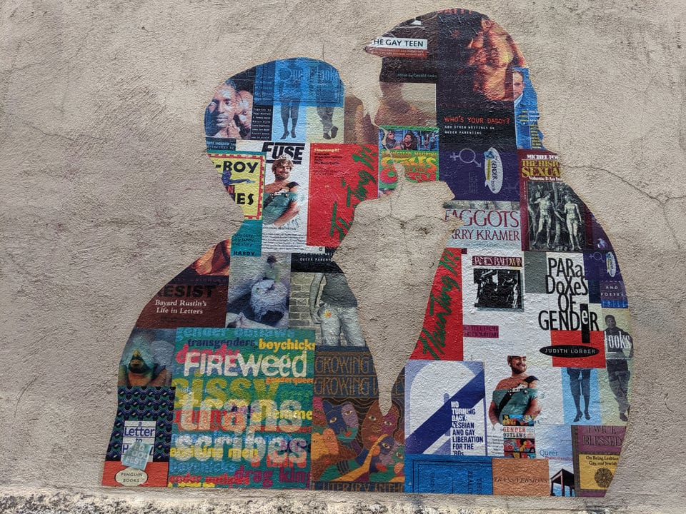 A mural showing two people kissing with their bodies made out of the covers of LGBTQIA+ publications
