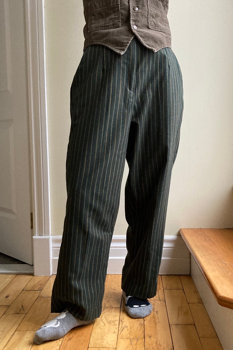 Dark green high waisted wool pants with thin beige vertical stripes