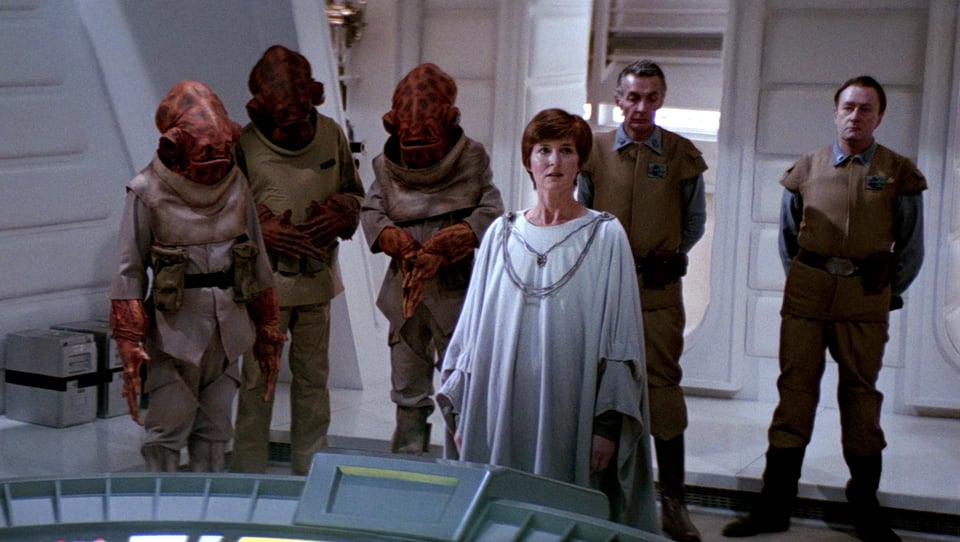 mon mothma standing with admiral ackbar and several rebels