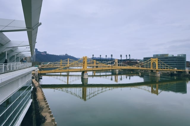 A yellow, steal suspension bridge crosses one of Pittsburgh’s rivers. Taken from the convention center, which has some pretty nice outdoor spaces.
