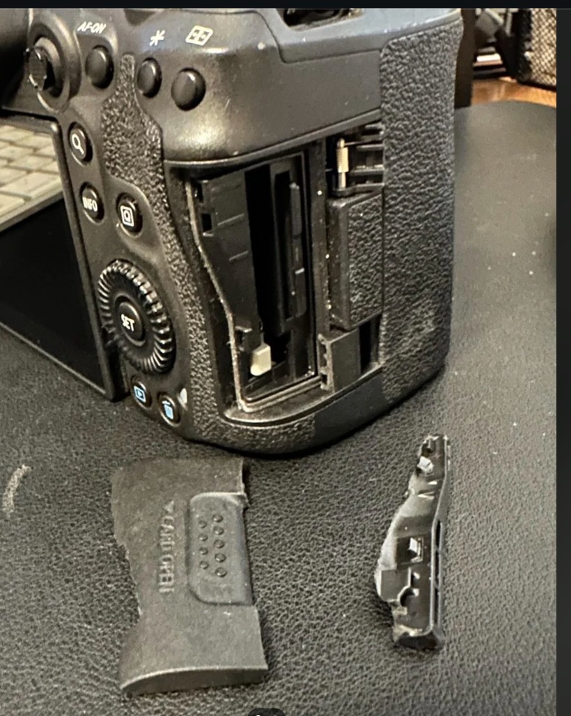 A Canon EOS 5D Mark IV camera with a shattered SD Card holder