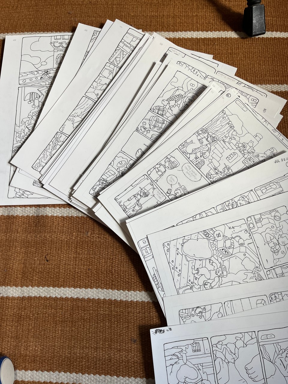 a pile of inked comic pages