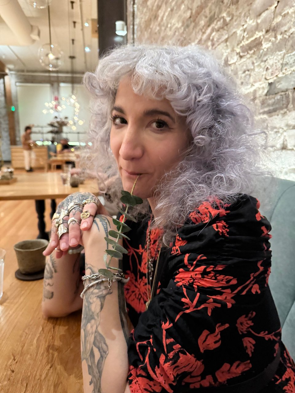 Cyn Grace Silvie with a sprig of eucalyptus in her mouth. Don't worry, she's not really a koala, she's eating the pine flavored creamcicle on the other end of that sprig.