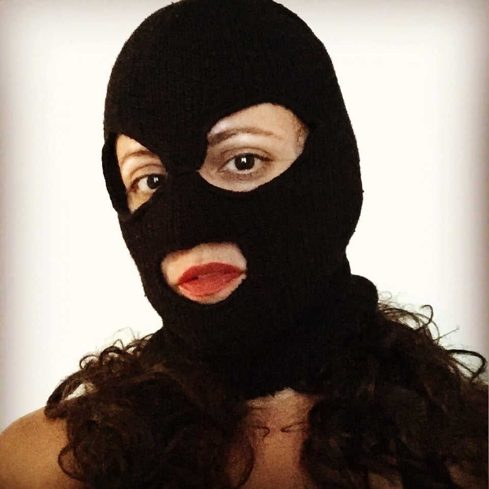 A person, Wendy, with red lipstick wearing a balaclava.