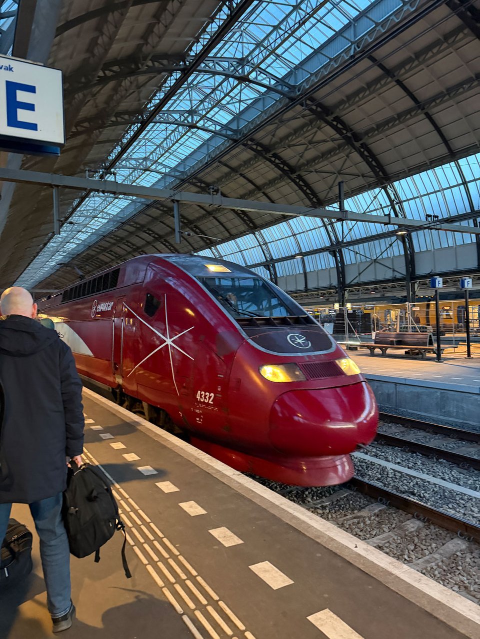 Red Eurostar train (formerly Thalys) pulling into the platform at Amsterdam Centraal.