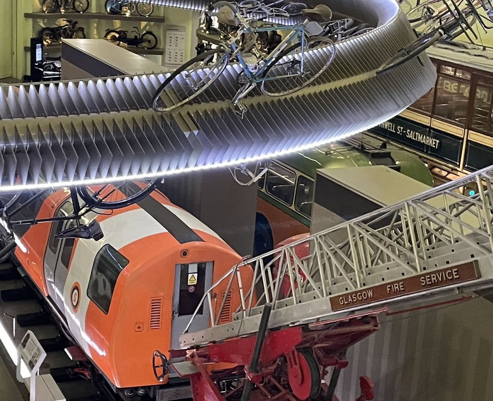 A composite photo of modes of transport: bicycles, motorbikes, a subway car and a tram car from Glasgow, and the ladder of a Glasgow Fire Service fire engine.