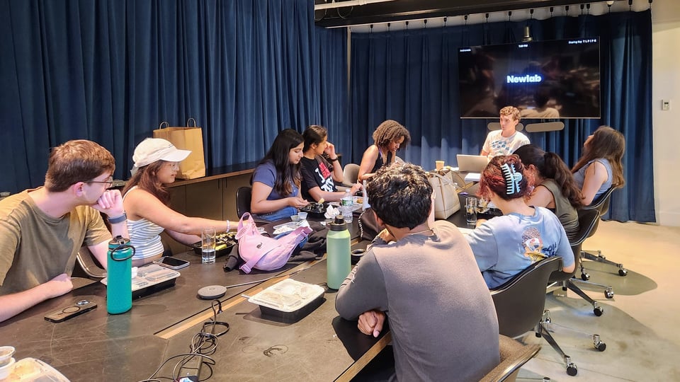 a group of people sitting around a table