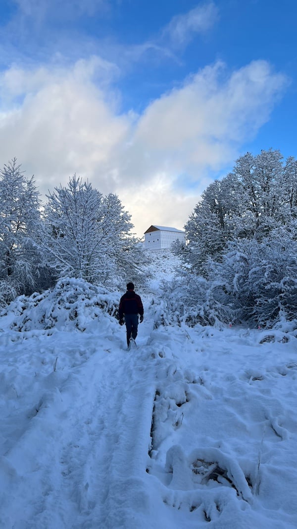 a person walking down a snow covered path