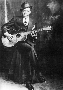 Old photo of Robert Johnson, an early blues guitarist and singer