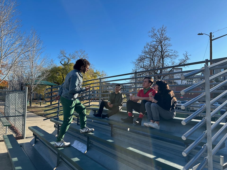 A few of us hanging out on some bleachers eating ice cream.