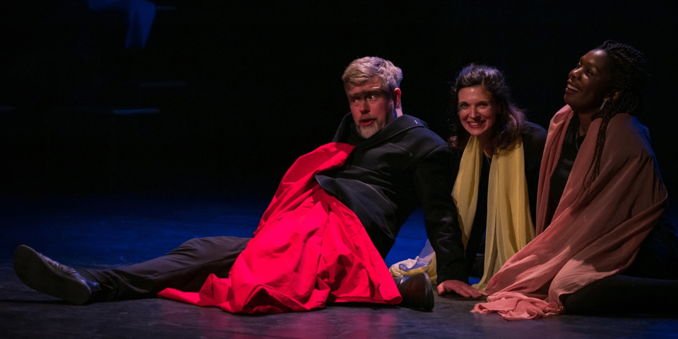 A performance of Mixed Omens - I’m on the floor, my leg at an odd angle.