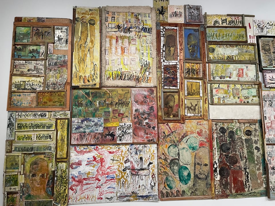 a solid wall of art from found materials and house paint