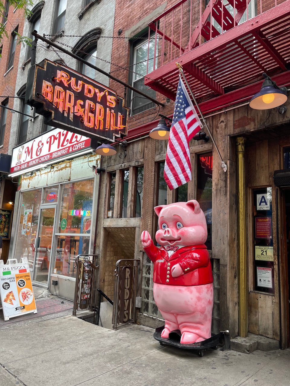 Huge fiberglass pig raising one hoof in greeting.