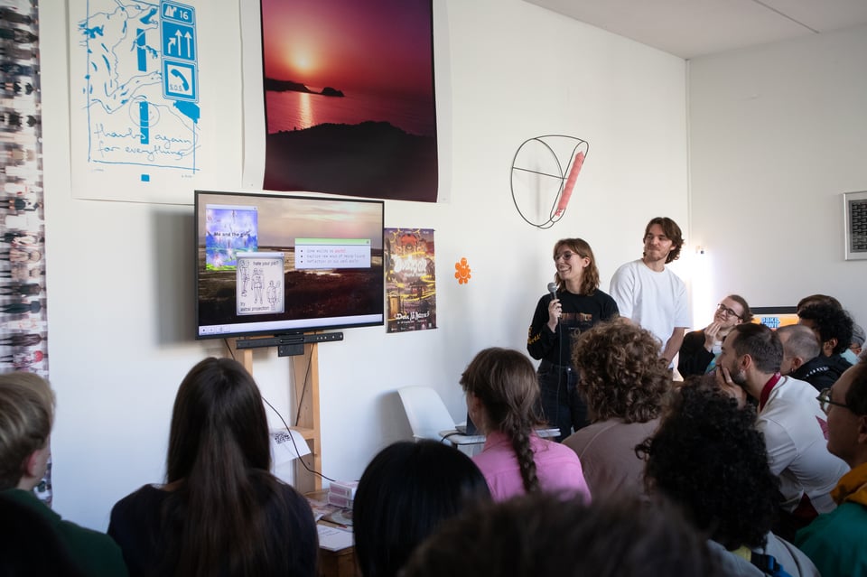 Two presenters talking in front of an audience