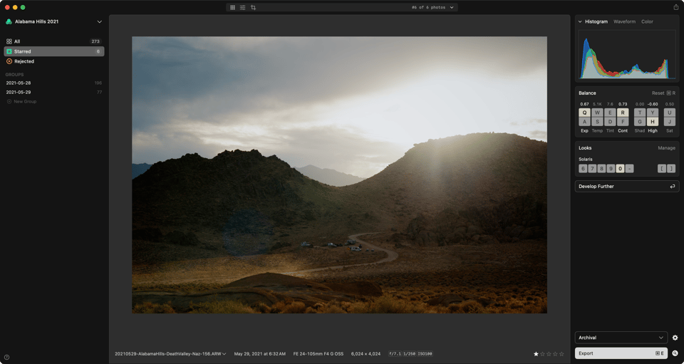 A photo of the desert and dramatic light and skies shown in the app against dark gray.