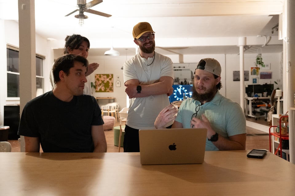 A group of people looking at a screen.