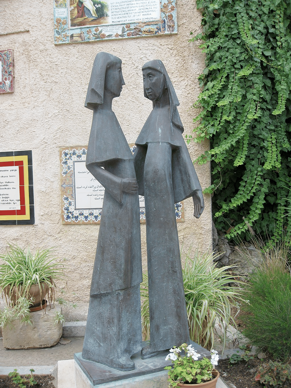 statue of two women in a garden