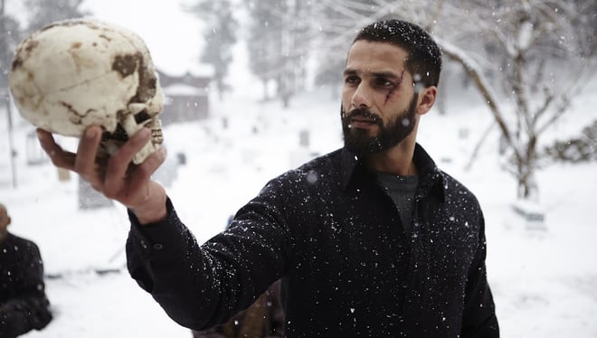 Shahid Kapoor in Haider holding a skull, symbolic of Hamlet.