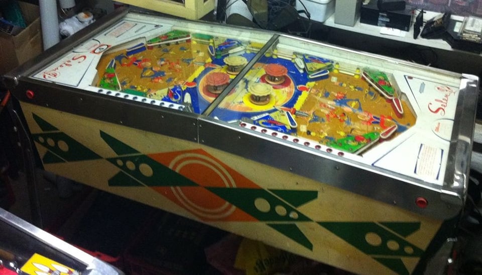 A two-player pinball machine where each player has an identical playfield which each makes up 50% of the whole game.