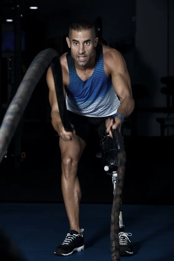 a man lifting a rope in a gym