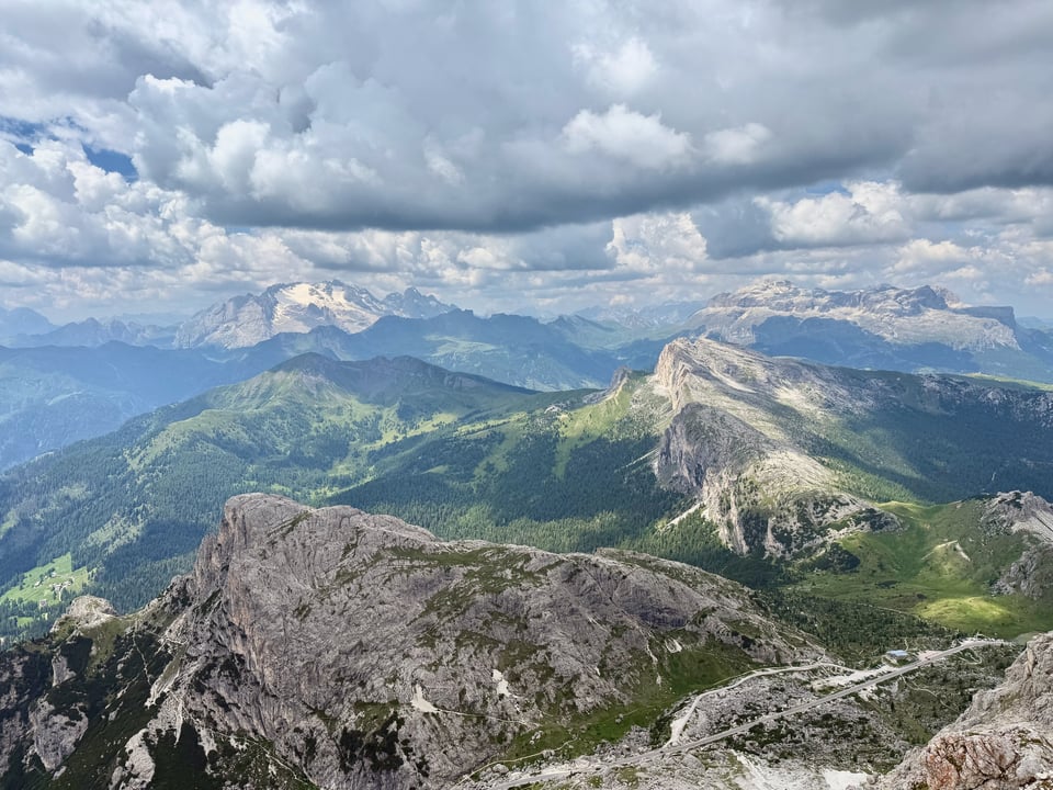 a mountain saddle with green and peaks in the background