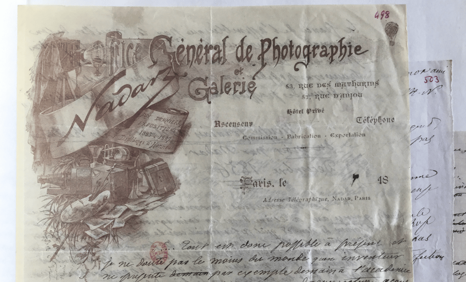 Printed letterhead for the Office général de photographie. The image shows various photographic materials, including a camera and a lamp. In the top right a small balloon is visible.