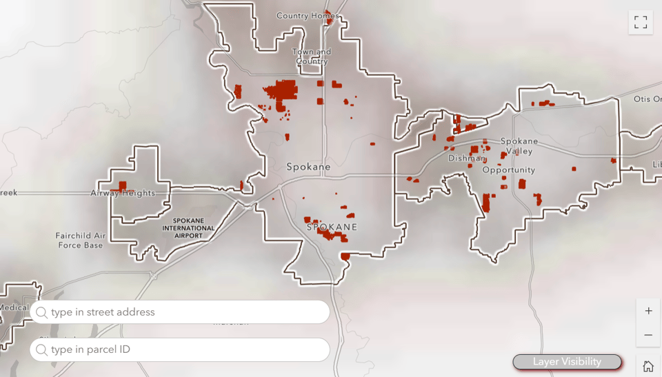 A map of Spokane County centered on the city of Spokane, Wash. with some properties filled in red.