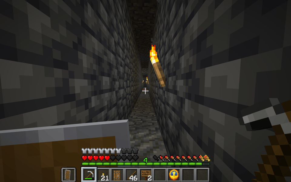 Picture of a Minecraft screen in which the player is in a deep underground tunnel with torches