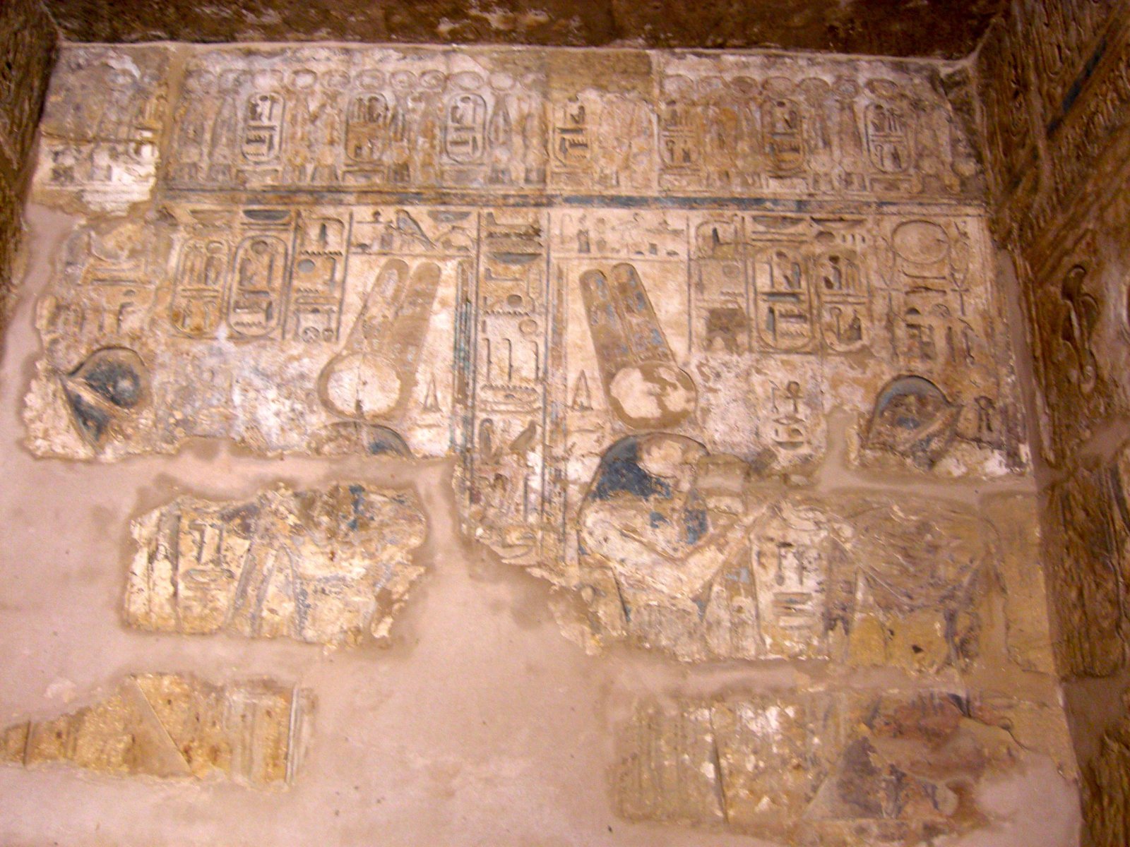 Painted hieroglyphs and relief carvings on the wall inside a tomb in the Valley of the Kings