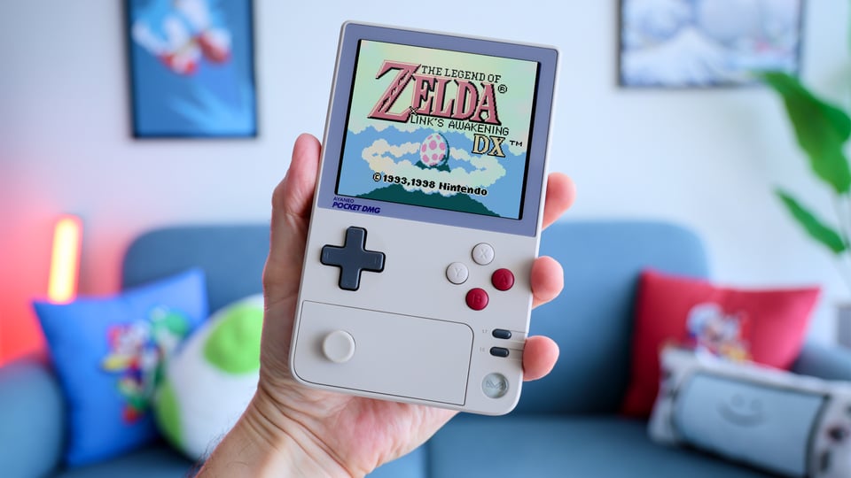 Russ holding AYANEO Pocket DMG, rocking Zelda
