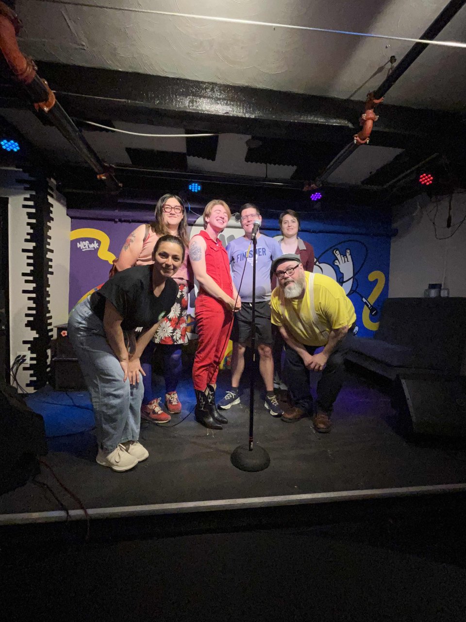 Myles, Nayeli, Kat, Zeke, MFG, March, and Katya (in spirit) posing on stage