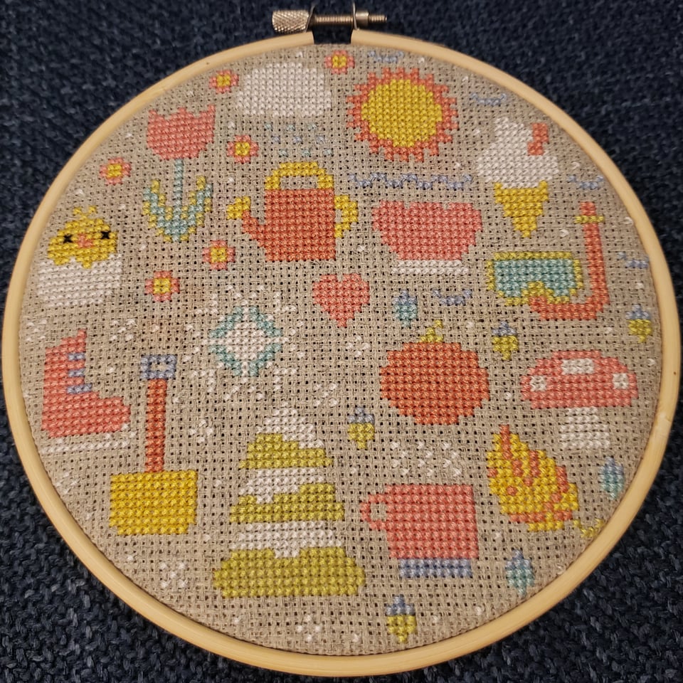 a cross stitch of seasonal motifs