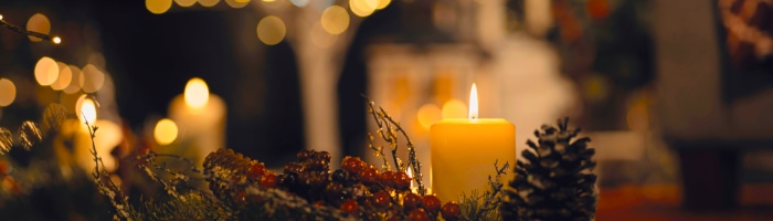 candles on a table at night with glowing light in the background