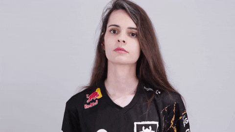 A white woman with long brown hair taps her chin thoughtfully.
